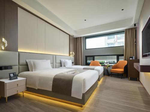 a bedroom with a large bed and a large window at Lumina Boutique Hotel in Zhangjiajie