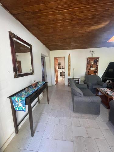 a living room with a table and a couch at Casa de chacra in Veinticinco de Mayo