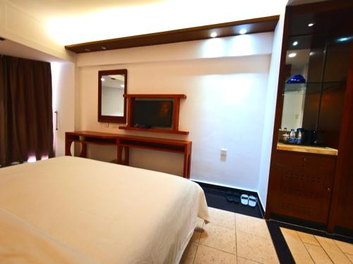 Postel nebo postele na pokoji v ubytování Sanya Tino Kangyi Seaview Holiday Hotel