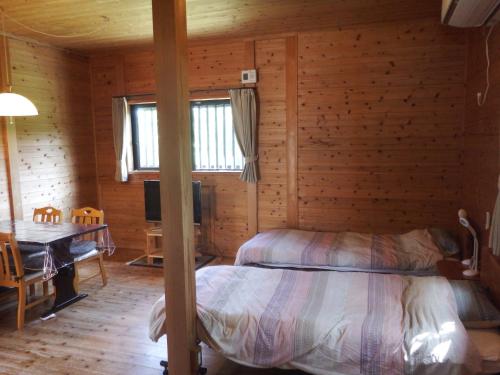 Un ou plusieurs lits dans un hébergement de l'établissement Green Cottage ＭＭ