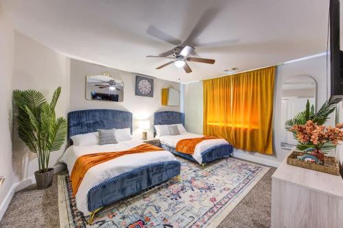a bedroom with two beds and a ceiling fan at Ultimate Getaway Explore Katy & Houston in Style in Katy
