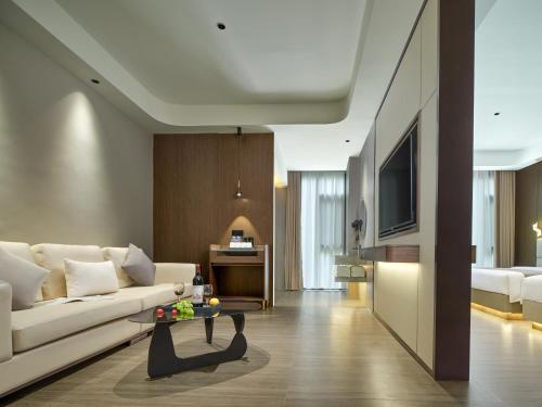 a living room with a white couch and a table at Lumina Boutique Hotel in Zhangjiajie