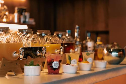 a table with a bar with glasses and drinks at そらすな Beach Side Resort Hotel in Yukuhashi