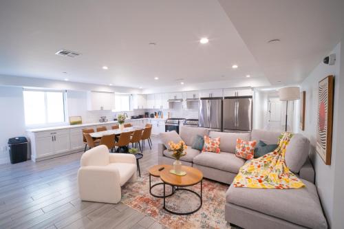 a living room with a couch and a table at Stylish Private Ensuite Room near USC in Los Angeles