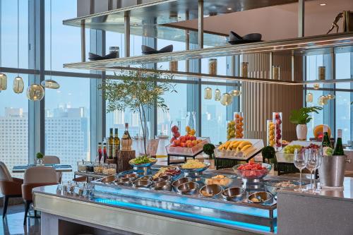 a buffet in a hotel with food and drinks at MaxX by Steigenberger Harbour-view Qingdao in Qingdao