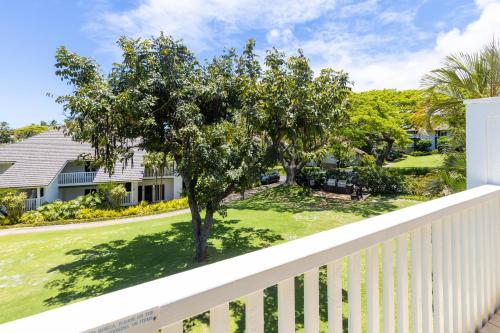 a view from the balcony of a house with a tree at Kiahuna Plantation Resort Kauai by OUTRIGGER in Koloa