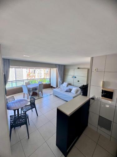 a kitchen and living room with a couch and a table at Studio Iracema 2001 in Fortaleza