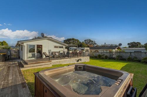 a hot tub in the yard of a house at Hosts on the Coast Cookies Cupboard in Pauanui