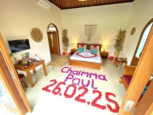 a bedroom with a bed with a sign on the floor at Romantic Villa in Ubud Private Pooll and Rice Fields View in Ubud