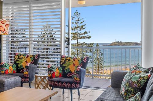 a living room with a view of the ocean at Syrenuse 22 in Mooloolaba