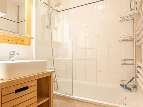 a white bathroom with a sink and a shower at Appartement duplex 6 pers, terrasse, connectivité, parking - FR-1-840-22 in Aussois