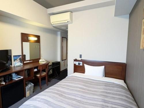 Postel nebo postele na pokoji v ubytování Hotel Route-Inn Utsunomiya Miyukicho -Kokudou4gou-