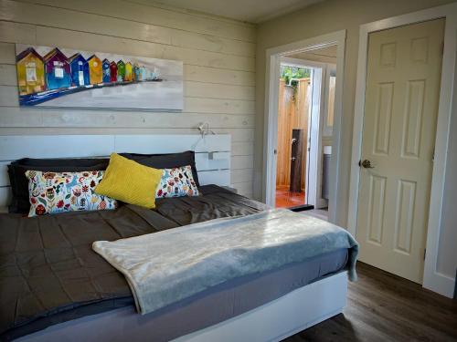 a bedroom with a bed and a painting on the wall at Whitecaps Cabana for Couples in La Have