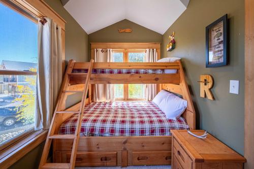 a bedroom with a bunk bed and a window at Riverbend views ten feet away in Granby
