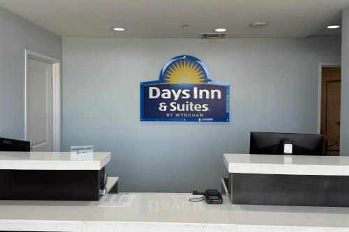 a days inn and suites sign on a wall in a room at Days Inn & Suites by Wyndham Colorado City/I-20 in Colorado City