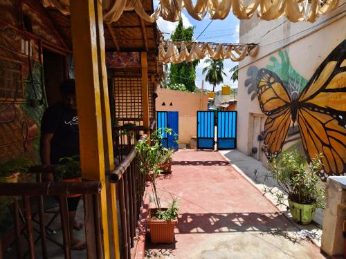 a butterfly painted on the side of a building at Durga HUTS in Hampi
