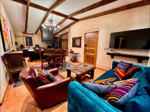 a living room with a blue couch and a table at Don Roque en ValQuirico in Santeagueda