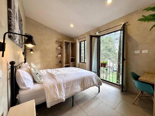 una camera da letto con un letto e una grande finestra di Sofia en ValQuirico a Santeagueda