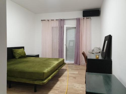 a bedroom with a bed and a tv and a table at Madame facances in Saïdia