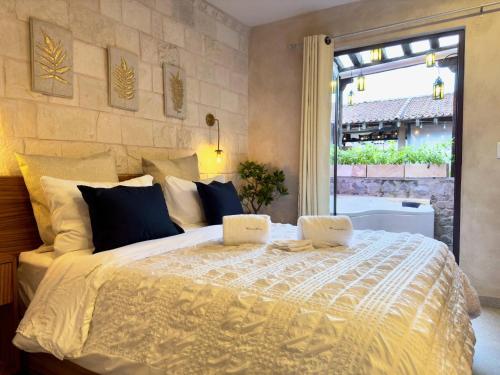 a bedroom with a large bed with two books on it at Mueganos 1 en ValQuirico in Santeagueda