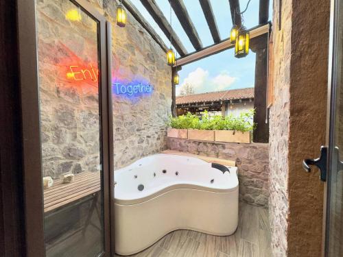 a bath tub in a bathroom with a window at Mueganos 1 en ValQuirico in Santeagueda