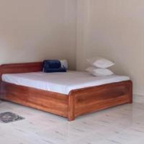 a bedroom with a bed with a blue bag on it at Aranyak Homestay By StayApart in Simāna Basti