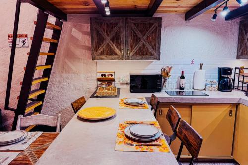 a kitchen with a long table with plates on it at Loft Iduri en ValQuirico in Santeagueda