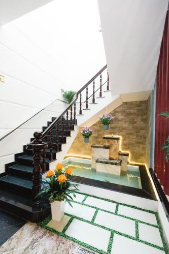 a pool in the floor of a house with stairs at VẠN LỘC HOTEL in Can Tho