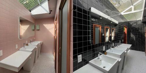 a bathroom with four sinks and a row of mirrors at Q Village Homestay Đà Lạt in Da Lat