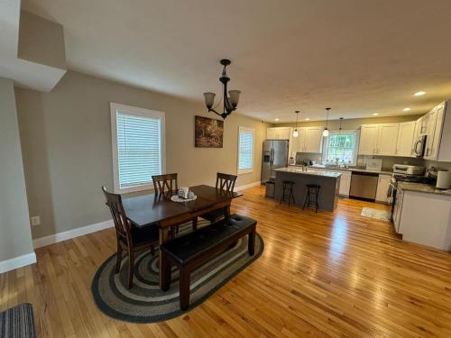 a kitchen and dining room with a table and chairs at Elegant 3BR Home in Worcester in Worcester