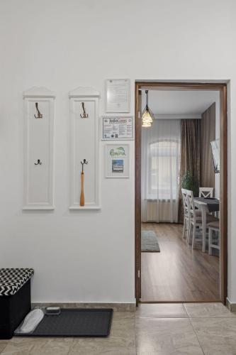 an open door to a living room with a table at White house parc Carol in Bucharest
