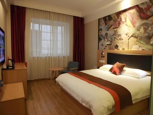 a hotel room with a large bed and a television at Jun Hotel Zhejiang Ningbo Luzhou District Zhongxing Nan Road in Ningbo