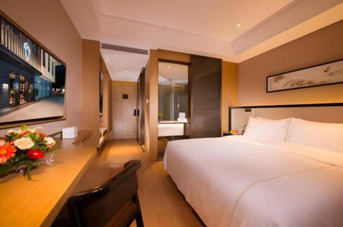 Ένα ή περισσότερα κρεβάτια σε δωμάτιο στο The Hotel V Nanjing Confucius Temple