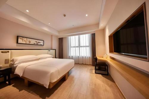 Ένα ή περισσότερα κρεβάτια σε δωμάτιο στο The Hotel V Nanjing Confucius Temple