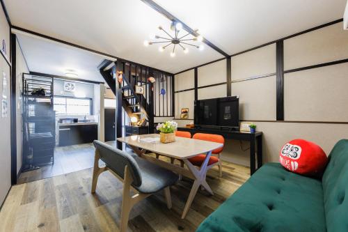 a living room with a table and a couch at 新大阪旅庵 民泊彩庵 in Osaka