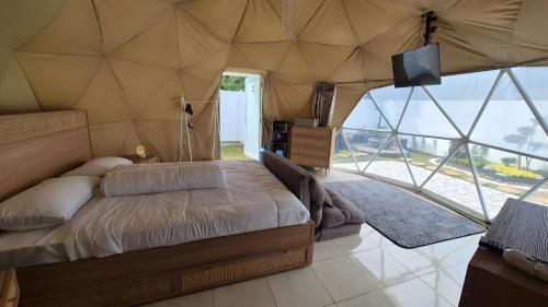 a bedroom with a bed in a tent at Mahkota Sangkuriang Bandung in Bandung