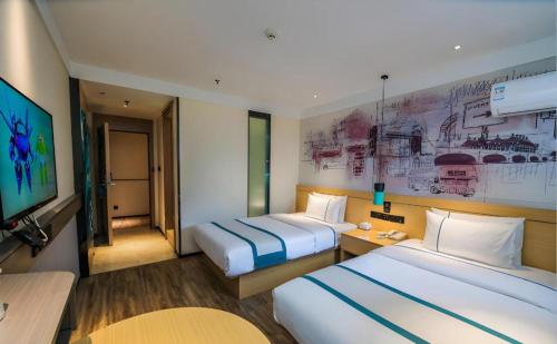 a hotel room with two beds and a tv at City Comfort Inn Kunshan Development Zone Penglang Xinxing Middle Road in Suzhou