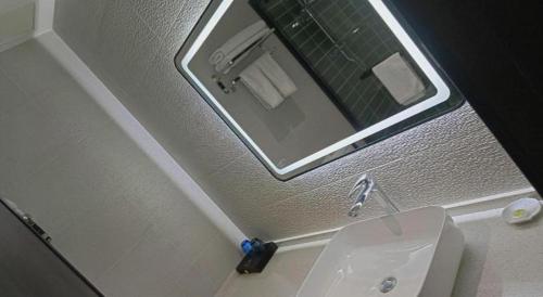 a bathroom with a sink and a mirror and a toilet at GreenTree Inn Express Datong High-Speed Railway Station Wanda Plaza Fangte in Datong