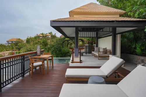 a deck with a gazebo next to a pool at Banyan Tree Cabo Marques in Acapulco