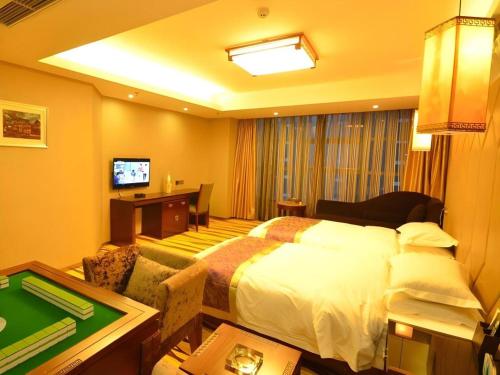 a hotel room with a large bed and a table at VX Hotel Chengdu Jiaolong Port Haibin in Chengdu