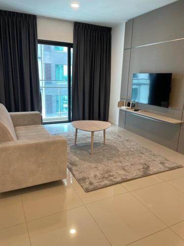 a living room with a couch and a table at Suasana Suites Johor Bahru City Centre in Johor Bahru