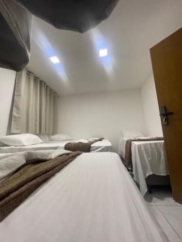 a bedroom with three beds in a room at Rede de Hotel 99 in Garanhuns
