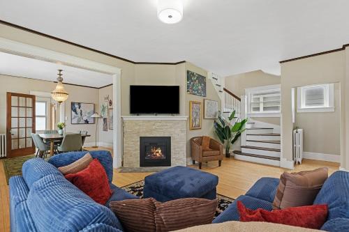 a living room with a blue couch and a fireplace at ArtGallery PrivateHotTub Sauna NearMountRushmore FamilyHome in Rapid City