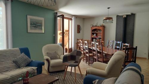 a living room with a couch and chairs and a table at Les balcons du Haut-Forez in Chalmazel Jeansagniere