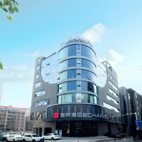 a large building with cars parked in front of it at Echarm Hotel Changsha Wuyi Square Xiangya Affiliated 1st Provincial Maternity and Child in Changsha