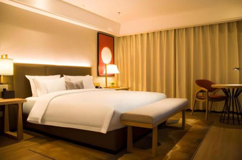 Ένα ή περισσότερα κρεβάτια σε δωμάτιο στο Echeng Hotel Enshi Minzu Road