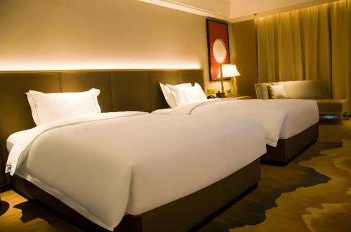 Ένα ή περισσότερα κρεβάτια σε δωμάτιο στο Echeng Hotel Enshi Minzu Road