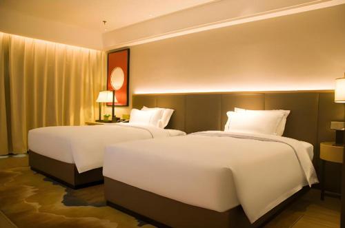 Ένα ή περισσότερα κρεβάτια σε δωμάτιο στο Echeng Hotel Enshi Minzu Road