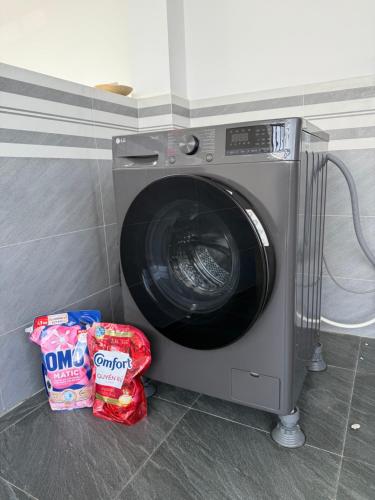 a washing machine in a kitchen with some chips at Villa 1985 in Buon Ma Thuot