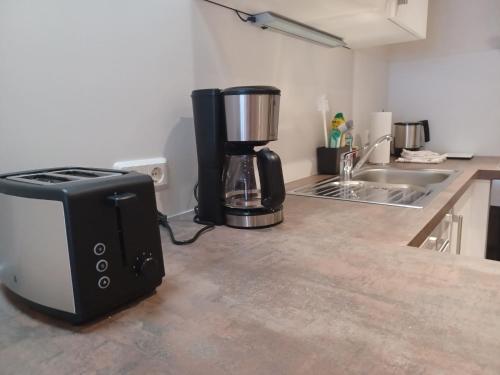 a kitchen with a toaster and a blender on a counter at Apartment am Fischbrunnen in Weikersheim